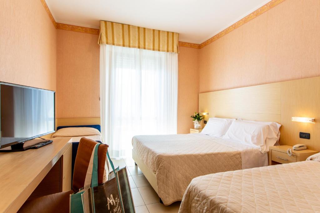 Postel nebo postele na pokoji v ubytování Hotel Metropole