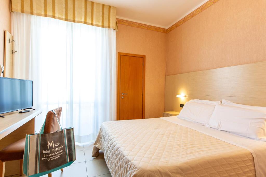 Postel nebo postele na pokoji v ubytování Hotel Metropole