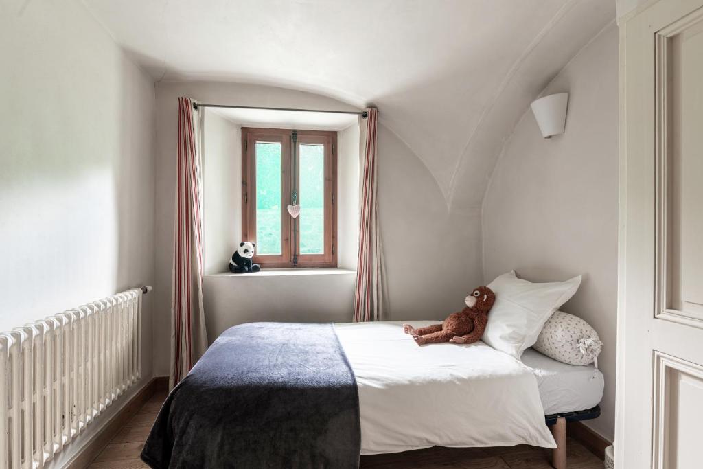 a teddy bear sitting on a bed in a bedroom at Bed end breakfast du centre in Bourg-Saint-Maurice