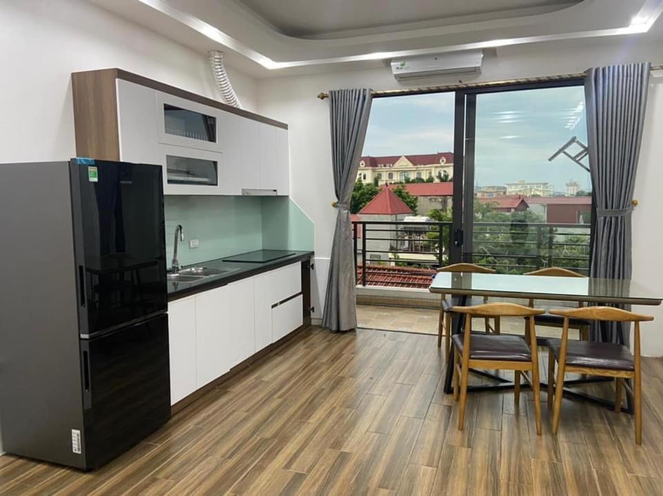 a kitchen with a table and a dining room at Căn hộ 1PN in Ninh Binh