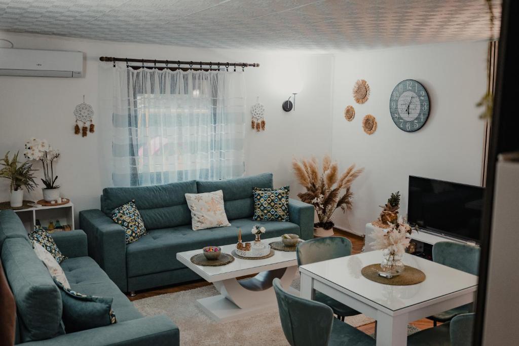 a living room with a couch and a table at Vikendica Fruškogorski kutak - Fruška Gora in Čerević