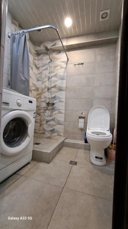 a bathroom with a washing machine and a toilet at Best apartments in downtown in Yerevan