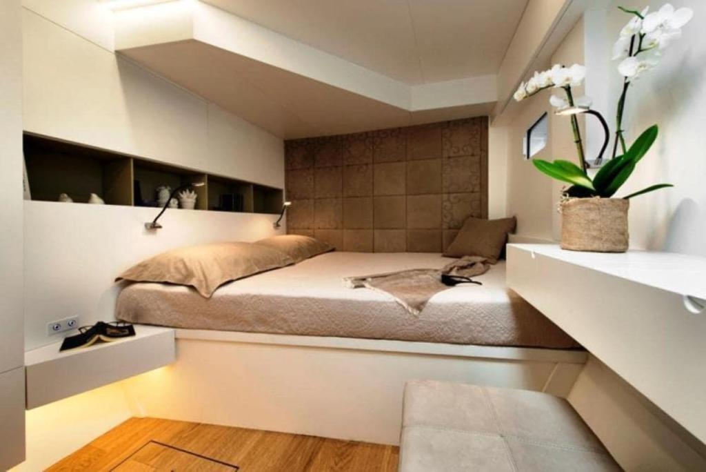 a bedroom with a bed in a small room at Luxury catamarano 20 meters in Marina di Portisco