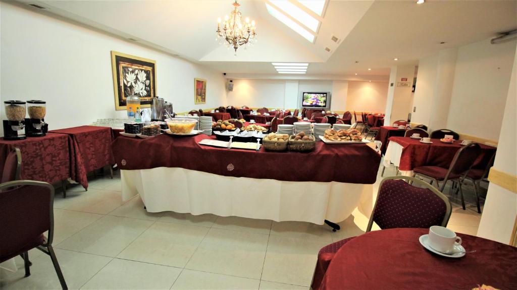 a banquet hall with a table with food on it at Hotel Guerrero in Mar del Plata