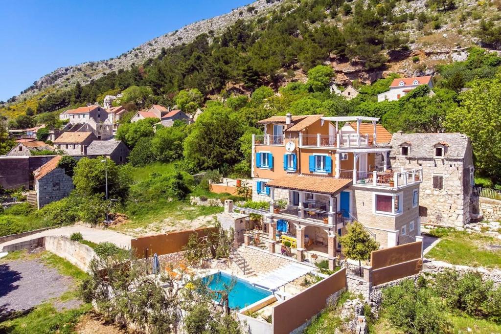 an aerial view of a house with a swimming pool at Two houses Villa Diana Jesenice with pool, sauna, playground in Jesenice