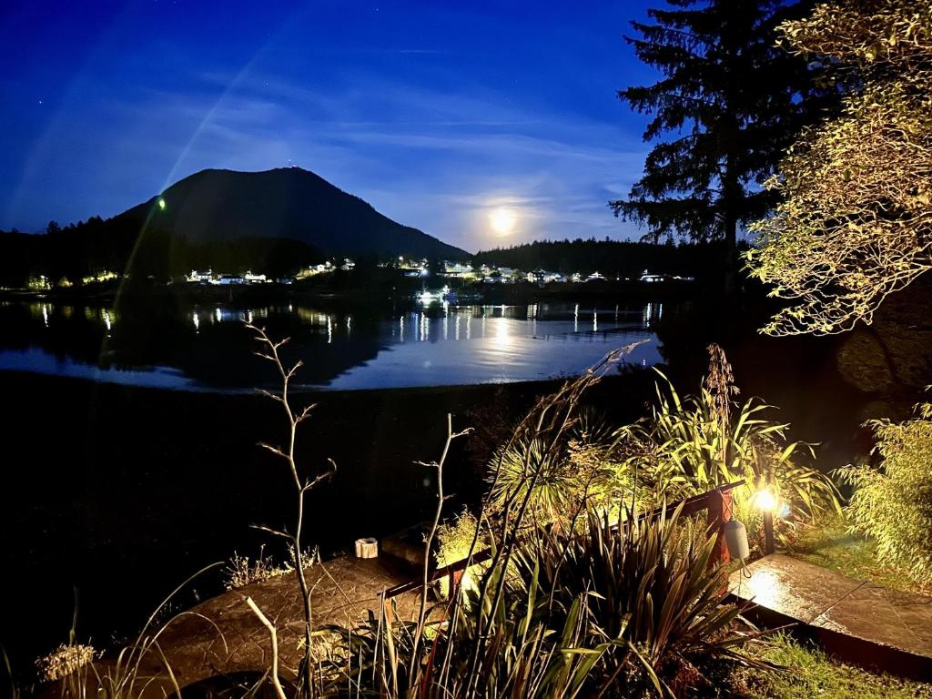 a view of a lake at night at Private Room On Waterfront Property With Hot Tub Firepit - Sea Esta in Ucluelet