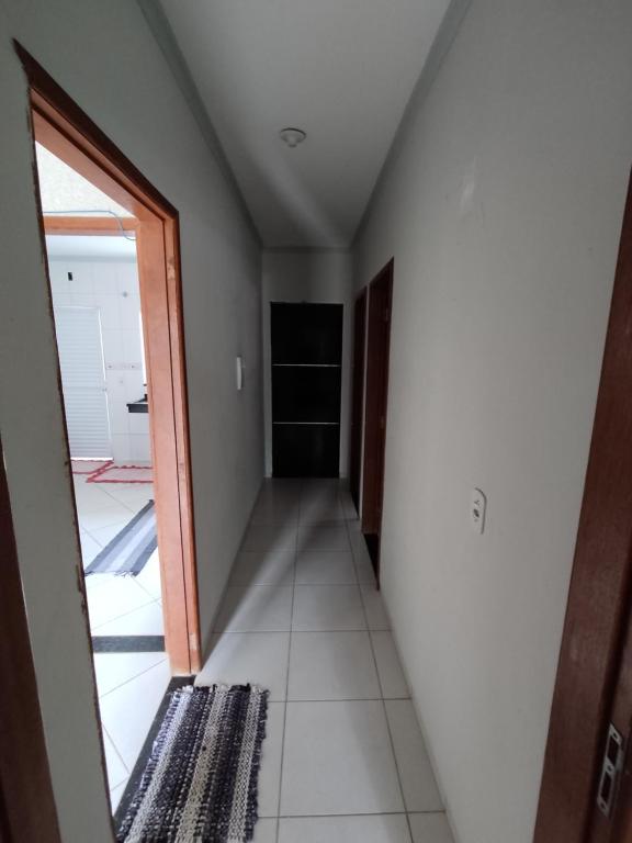 a hallway in a house with a door and a room at Casa toda privada 1 in Primavera do Leste