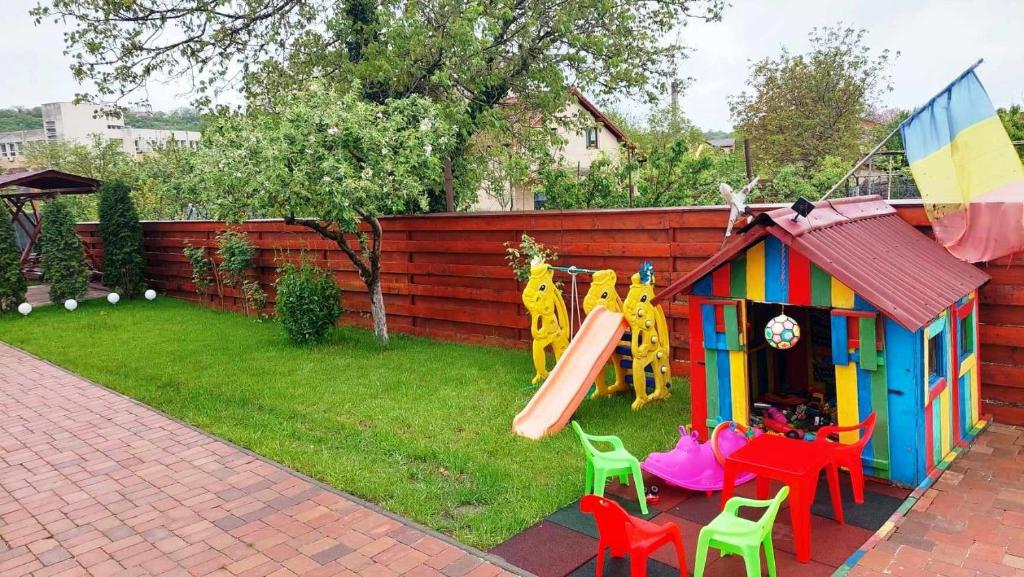 a playground with a slide and a play house at Casa SOL in Turda