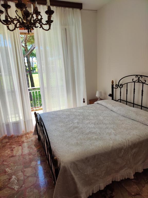 a bedroom with a bed and a large window at Casa di Gino in Pontedera