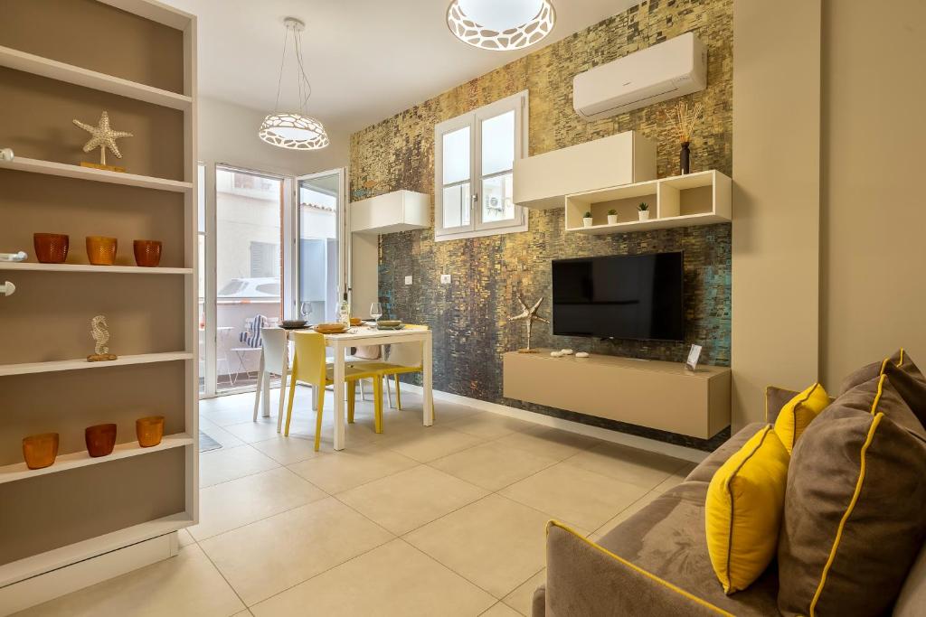 salon z kanapą i jadalnią w obiekcie Luxury Sofia Home Alghero w mieście Alghero