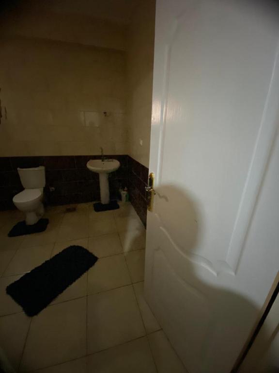 a bathroom with a white toilet and a sink at Home north cost in Sīdī Sālim
