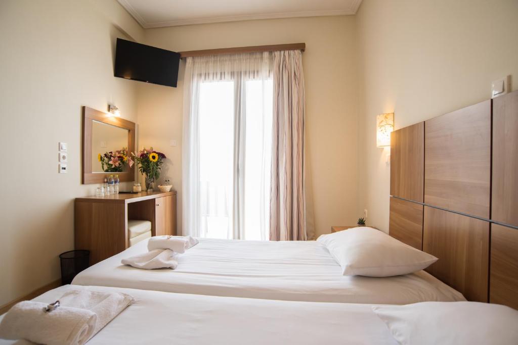 Postel nebo postele na pokoji v ubytování THOLOS HOTEL