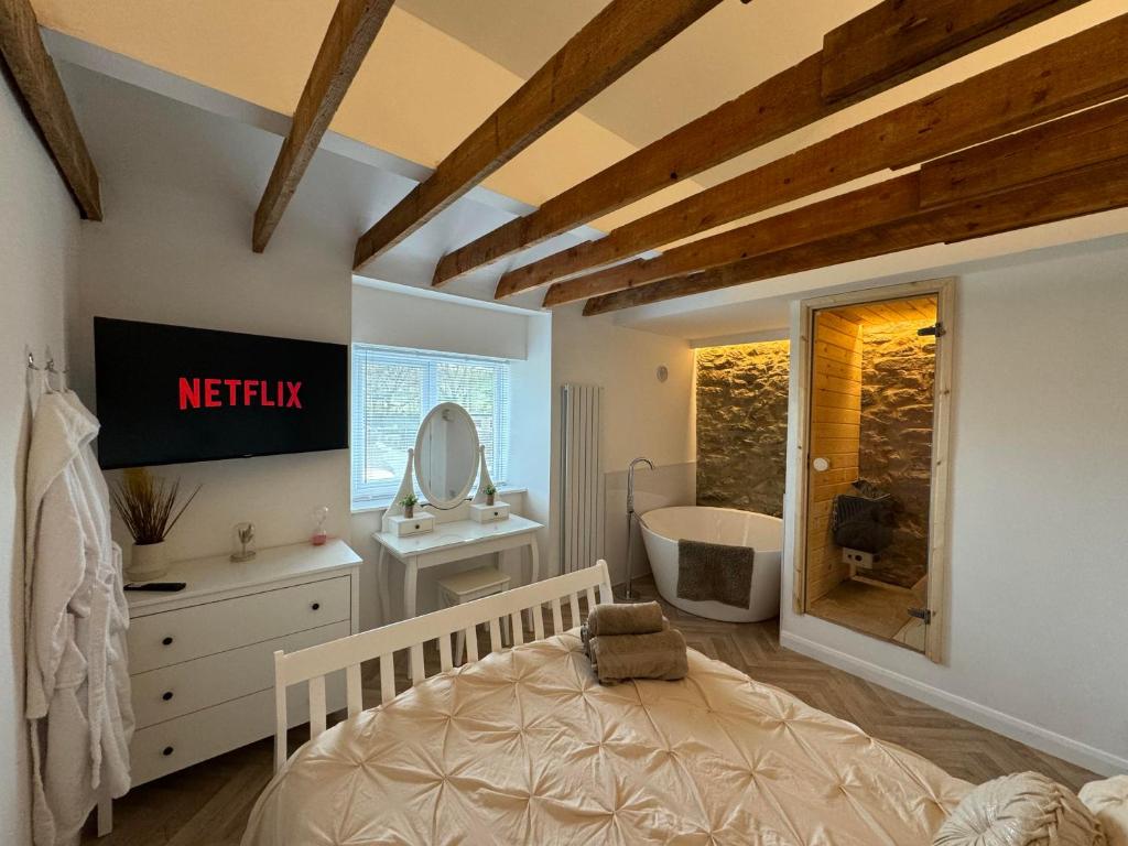A television and/or entertainment centre at Durham Dales Luxury Cottage