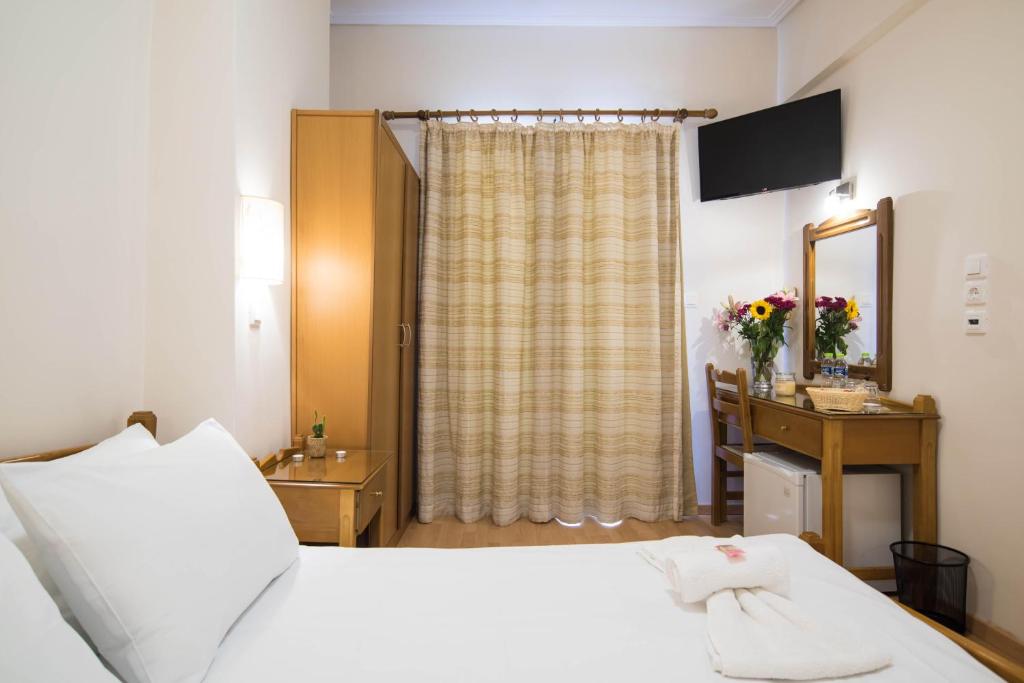 Postel nebo postele na pokoji v ubytování THOLOS HOTEL