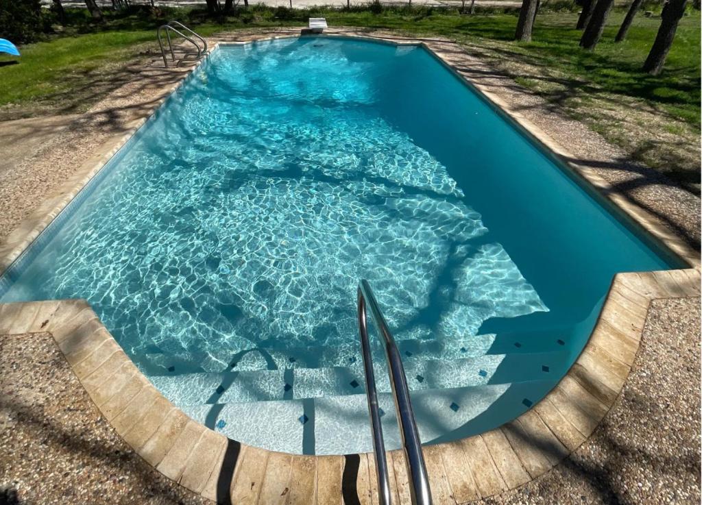 a swimming pool with stairs in the water at Hill Country House & Pool - Fiesta Texas Sea World in San Antonio