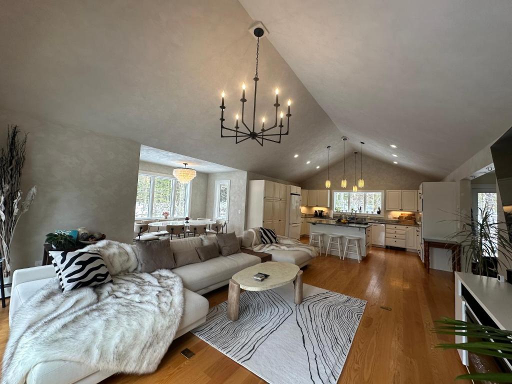 a large living room with a couch and a table at Modern House Family Retreat in Bar Harbor