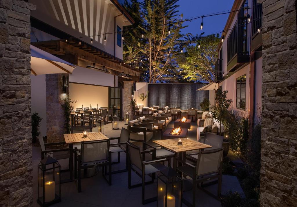 an outdoor restaurant with tables and chairs at night at Stilwell Hotel in Carmel