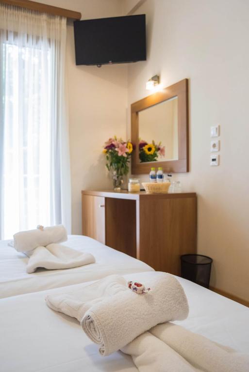 Postel nebo postele na pokoji v ubytování THOLOS HOTEL