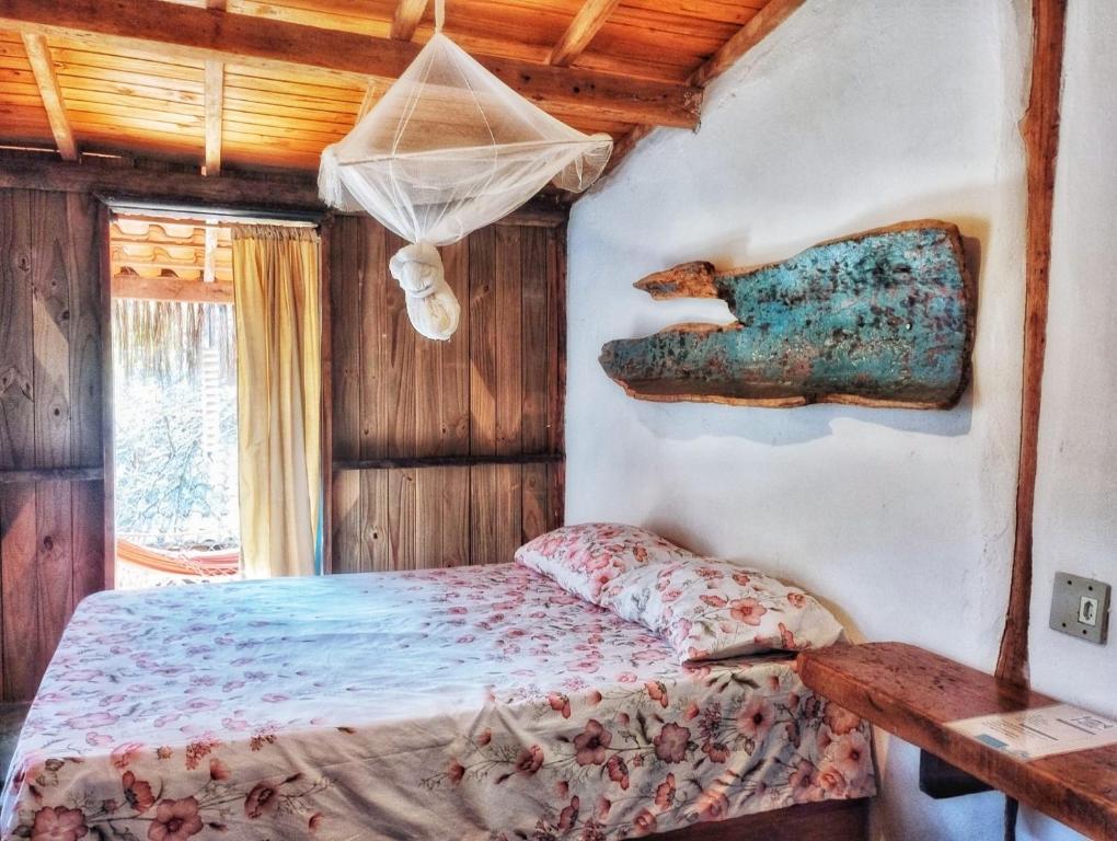 a bedroom with a bed and a wooden ceiling at Pousada Roy Bonete in Ilhabela