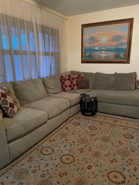 a living room with a couch and a rug at House next to the golf course in Plantation