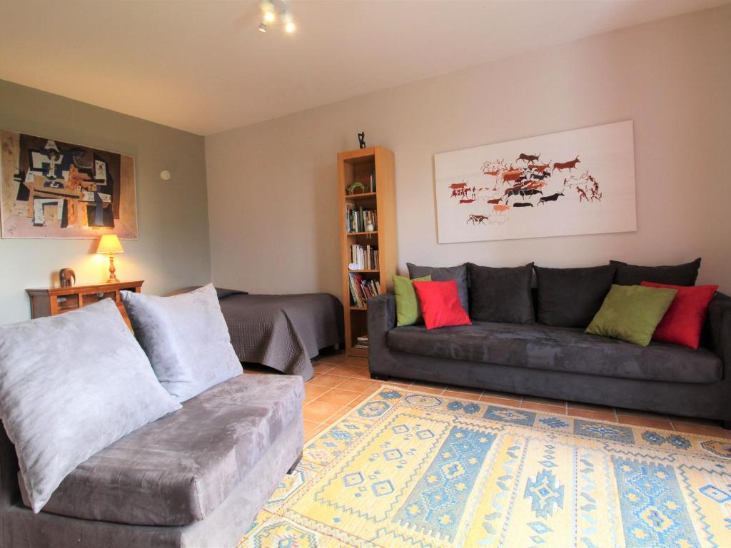 a living room with two couches and a rug at Charmant gîte familial avec jardin et Wifi, animaux admis - FR-1-622-77 in Vihiers