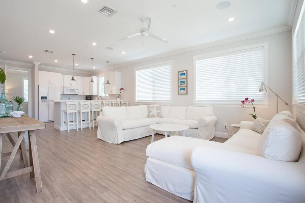 a living room with white furniture and a kitchen at Isla Key Lychee - Waterfront Boutique Resort, Island Paradise, Prime Location in Islamorada