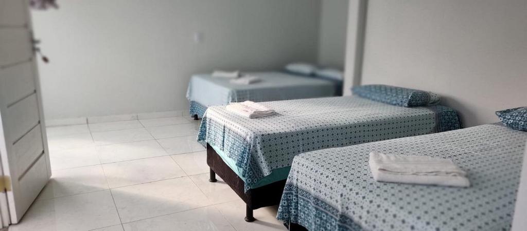 Ліжко або ліжка в номері Pousada Recanto Itaúnas