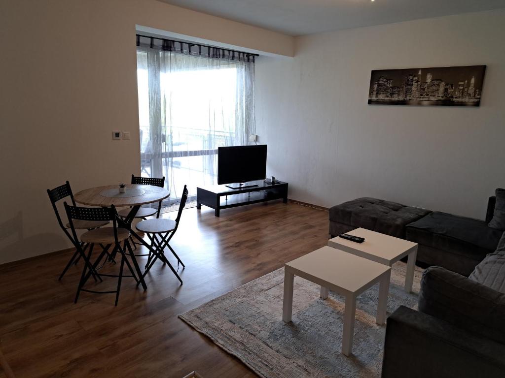 a living room with a couch and a table at Apartmán Zuzu FREE Parking in Trenčín