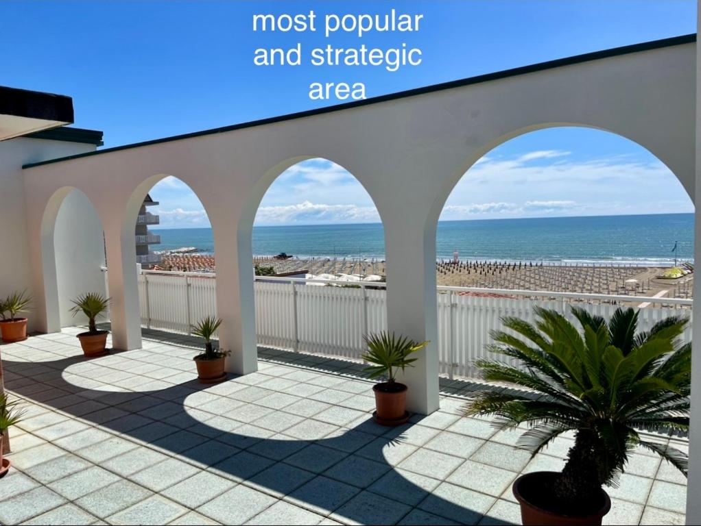 a patio with a view of the beach at Hotel Erika in Caorle