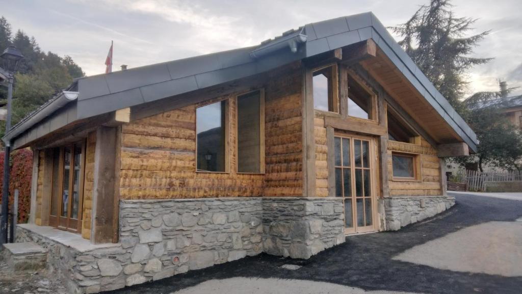a log cabin with a black roof at Chalet Balnéo Billard La Plagne Savoie Vue TOP in La Plagne Tarentaise