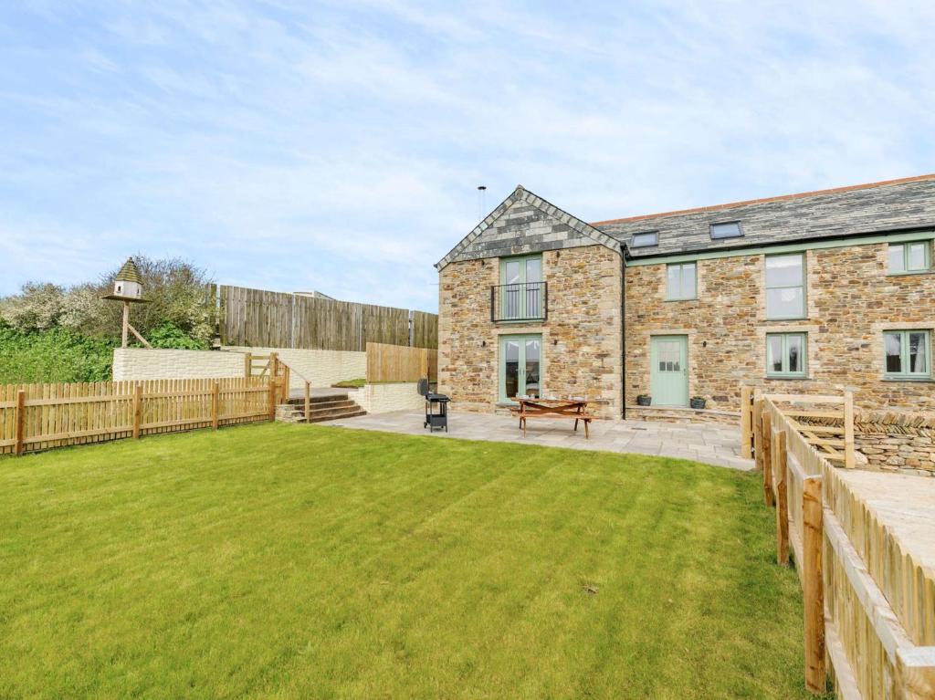 a brick house with a lawn in front of it at 3 Bed in Newquay 89943 in Mawgan Porth