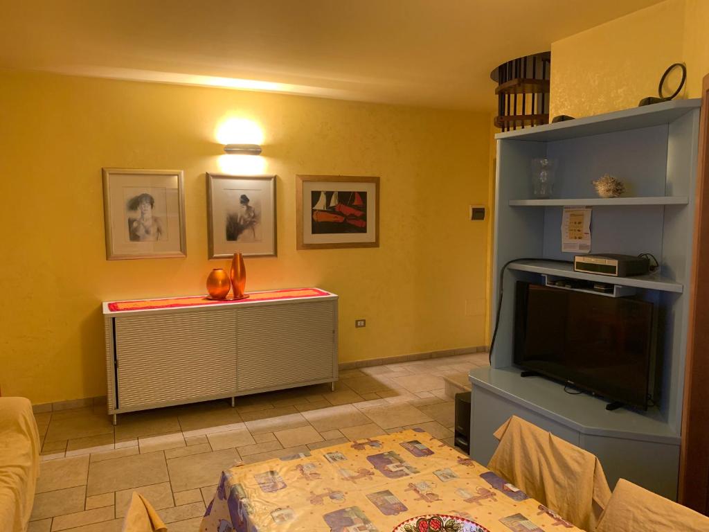 a living room with a flat screen tv and a couch at Rosemary 2 in Fano