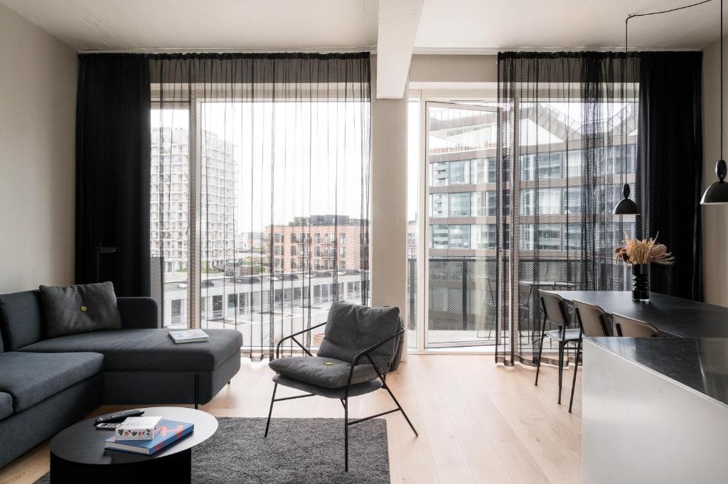 a living room with a couch and a table at The Pier apartments by Daniel&Jacob's in Copenhagen