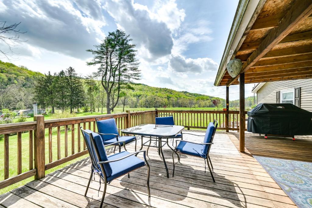 a patio with a table and chairs on a deck at Cozy Huntingdon Escape 19 Mi to Penn State Univ! in Huntingdon