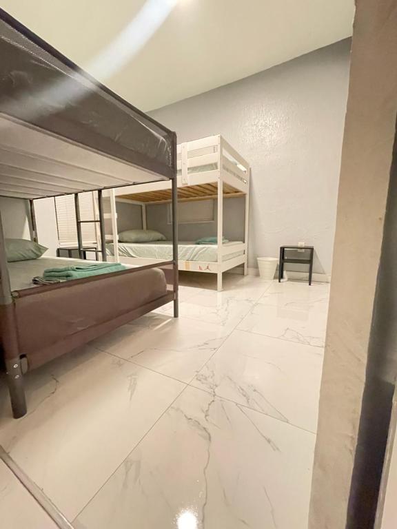 um quarto com 2 beliches e piso em azulejo em Mokulele em Miami