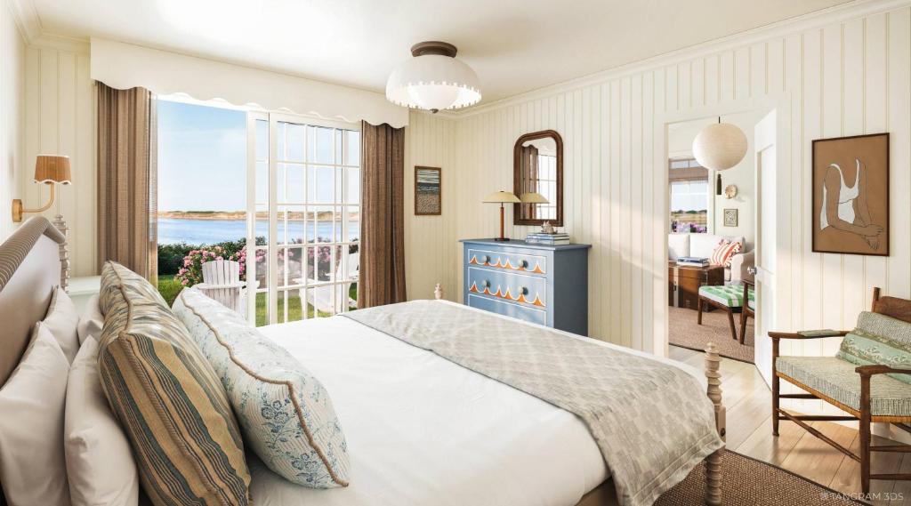 a bedroom with a bed and a view of the ocean at The Dunes on the Waterfront in Ogunquit