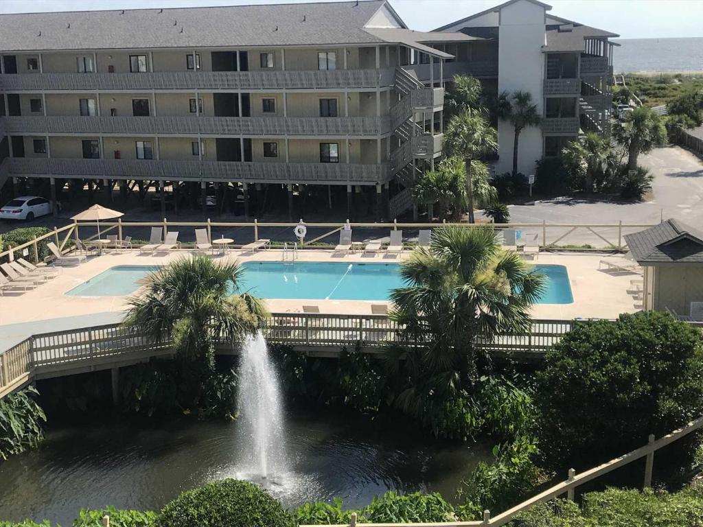 a pool with a fountain in front of a building at Lighthouse Point Rental 8B in Tybee Island