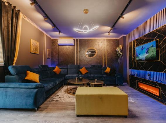NevesinjeにあるNL Studio Apartmentsのリビングルーム(青いソファ、暖炉付)