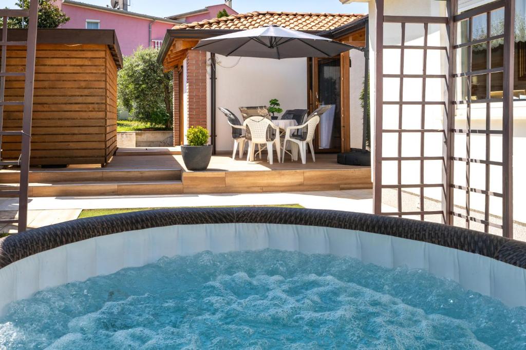 a hot tub in the backyard of a house at Palmira Apartments in Poreč