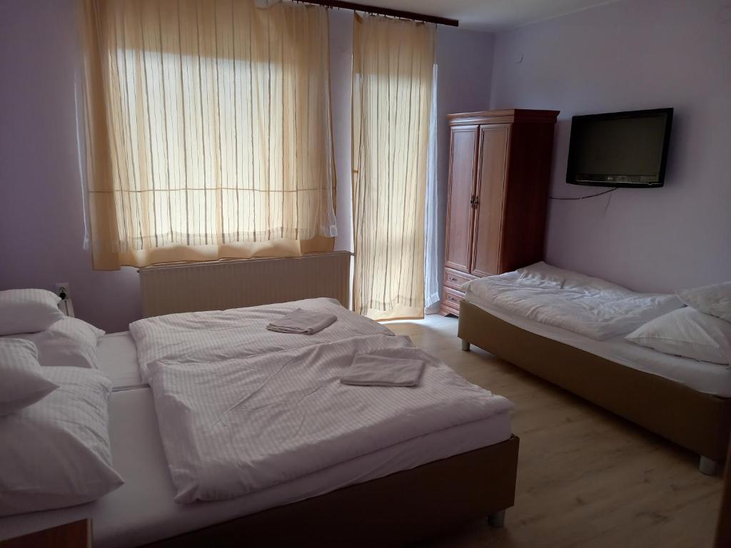 Postel nebo postele na pokoji v ubytování Öreg Tengerész Vendégház