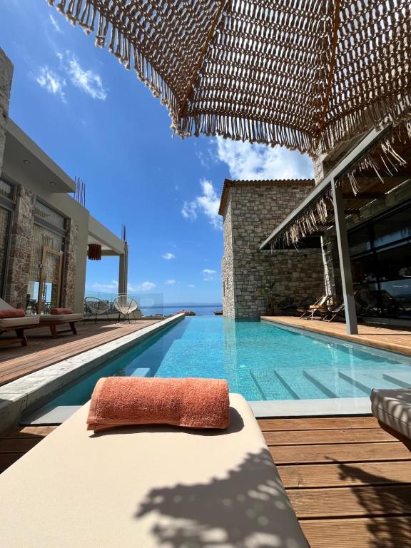 a pool at a resort with a bed and a view at Petrichor in Kalamata