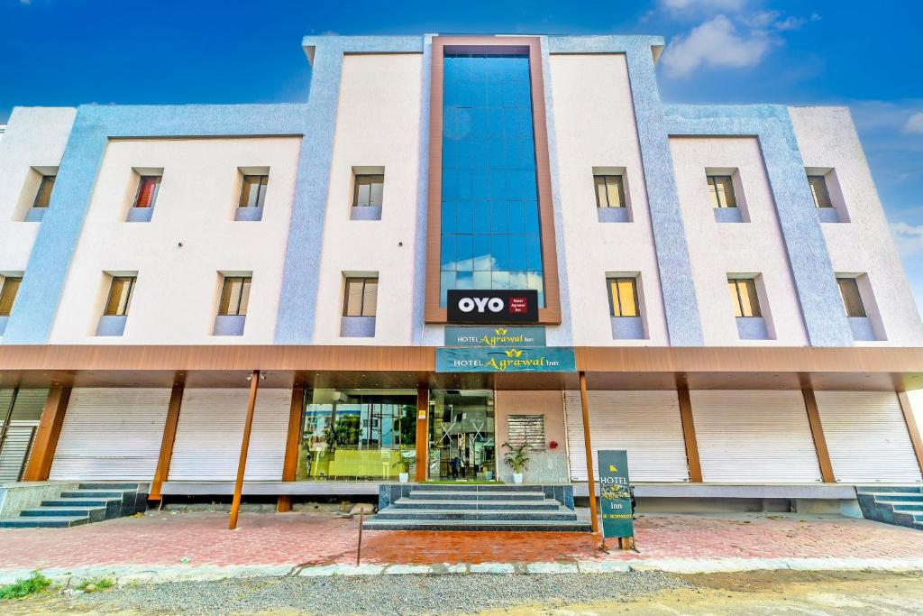 a building with a qooc sign on the front of it at OYO Hotel Agrawal Inn in Bhopal