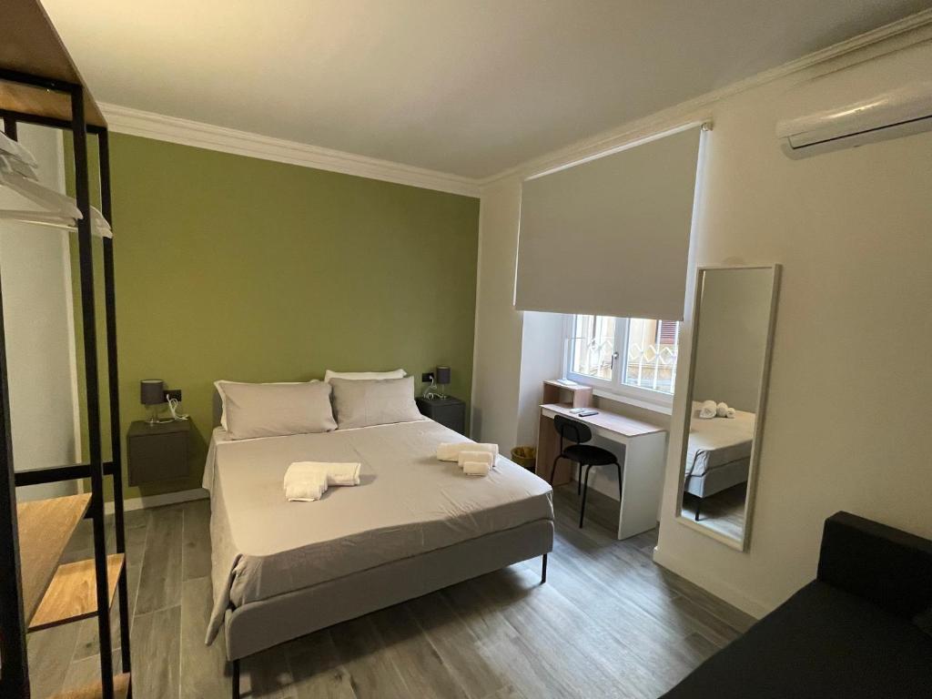 a bedroom with a bed with two towels on it at This must be the place Rome Guesthouse in Rome