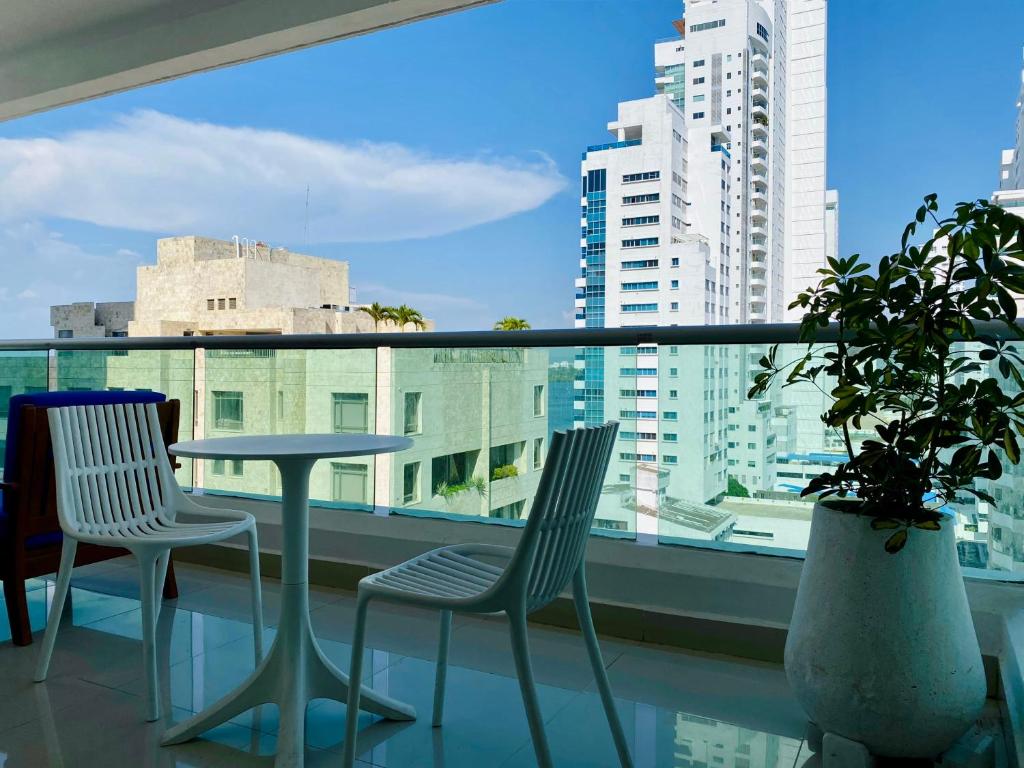 balcón con mesa, 2 sillas y ventana en Wonderful 2BR with impressive view en Cartagena de Indias