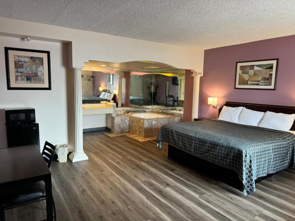 a hotel room with a bed and a bathroom at Express Inn-Rahway in Rahway