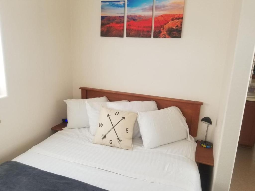 a bedroom with a bed with a clock on it at 083A Affordable Getaway near South Rim Sleeps 6 in Valle