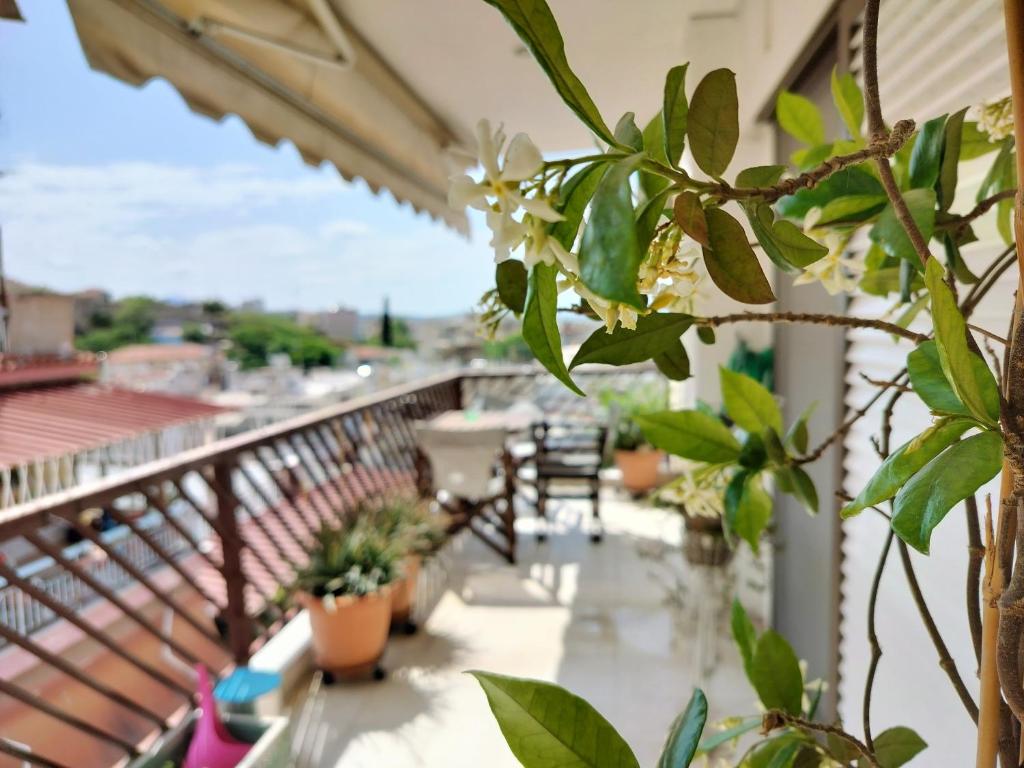 a balcony with plants and a table and chairs at CastleView 2BR Spacious Apartment with City View in Thessaloniki