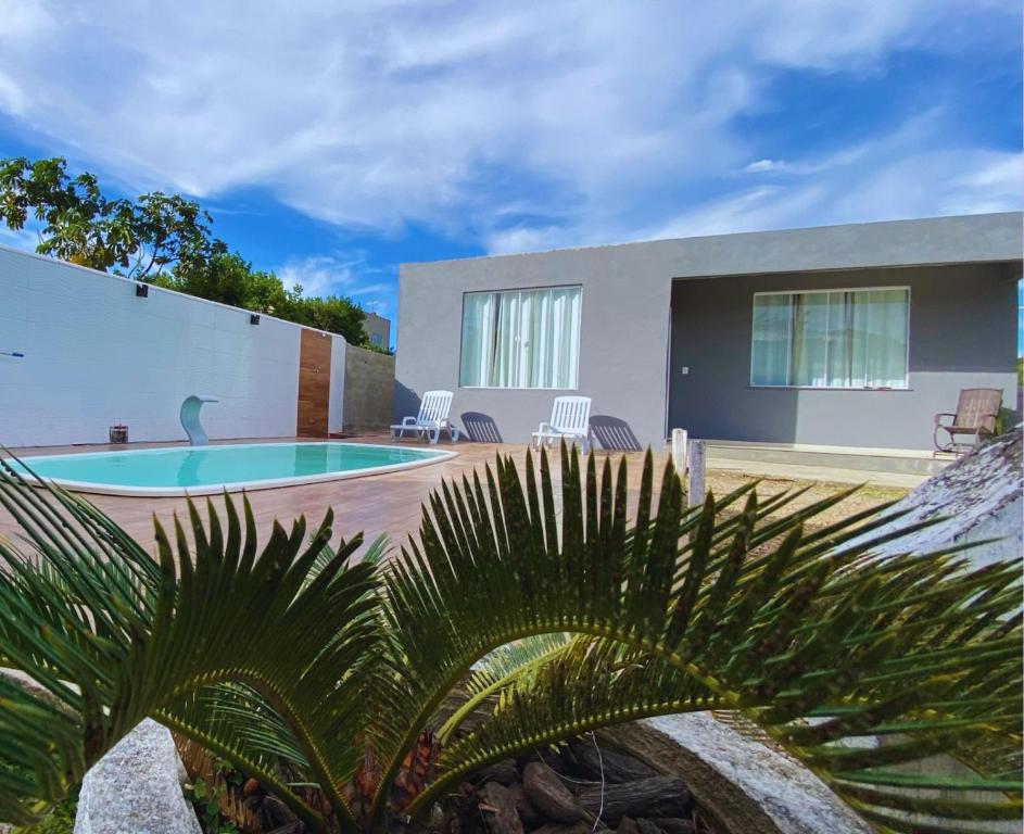 a house with a swimming pool in the backyard at Casa Ilha de Búzios in Búzios