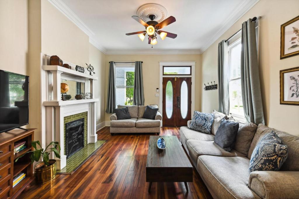 a living room with a couch and a fireplace at Stunning Uptown 3 Bedroom 3 Bathroom home in New Orleans