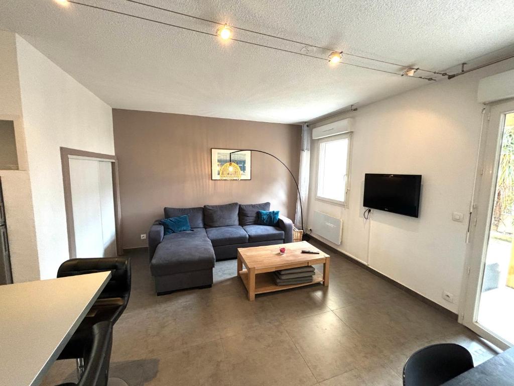 un salon avec un canapé et une table dans l'établissement Maison de la Plage N°4, au Grau-dʼAgde